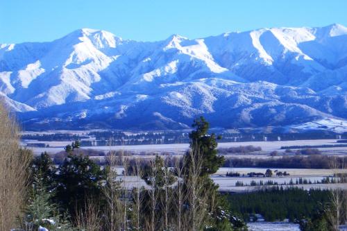 a mountain range with snow covered mountains at Amuri Estate Luxury Lodge in Hanmer Springs