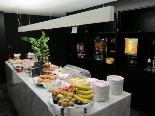 a buffet with fruits and vegetables on a table at Corbie Mol in Mol