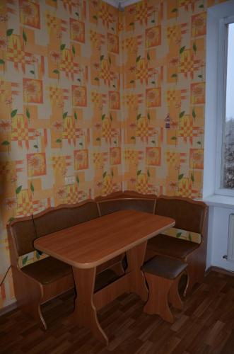 a table and chairs in a room with wallpaper at Bon Apart Naberegna in Mykolaiv