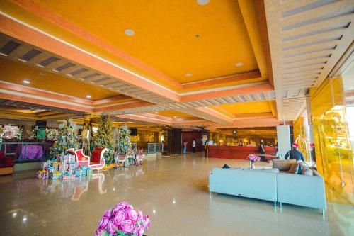 a large lobby with a lot of furniture and flowers at Butuan Grand Palace Hotel in Butuan