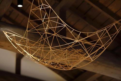 a wire basket hanging from a ceiling at Yufuin Souan Kosumosu in Yufuin