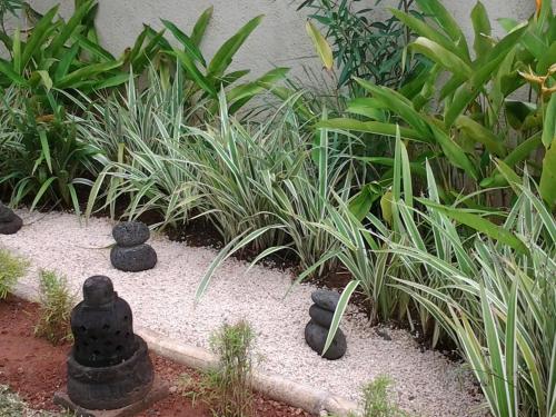 a garden with black stones in a garden with plants at Villa The Flows at Belle Rivière in Bel Ombre