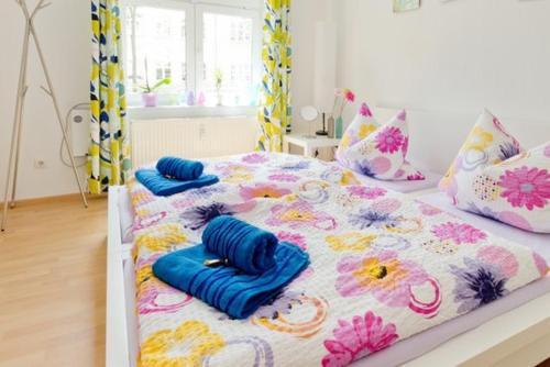a bedroom with two beds with blue pillows on them at Ferienwohnung City in Erfurt