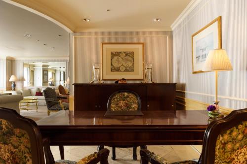 a living room with a table and a fireplace at Dai-ichi Hotel Tokyo in Tokyo