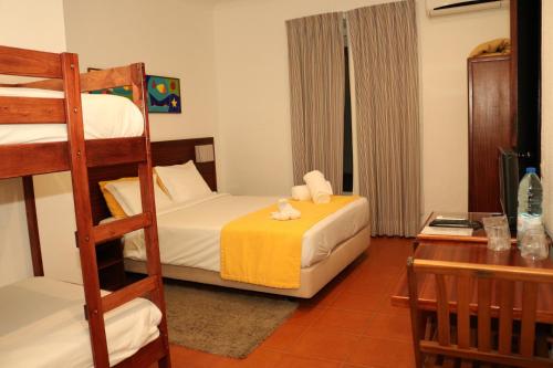 a bedroom with a bunk bed and a desk at Residencial Mar e Sol in Costa da Caparica