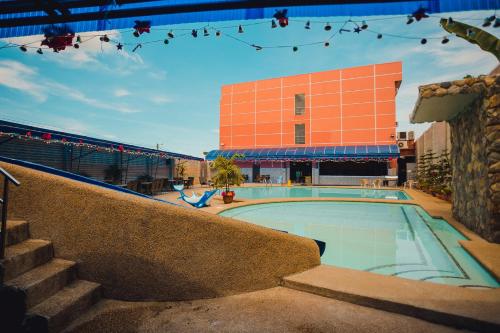 a swimming pool in front of a building at Butuan Grand Palace Hotel in Butuan