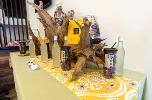 a table with a tree and bottles on it at T. T. House in Hengchun