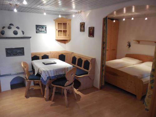 a room with a table and a bed and a bedroom at Landhaus Santner - Örglwirt's Ferienwelt in Mariapfarr