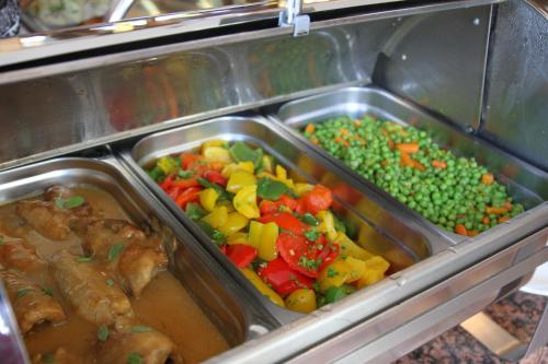 a tray of food with different types of vegetables at Hotel Am Tiergarten in Nürburg