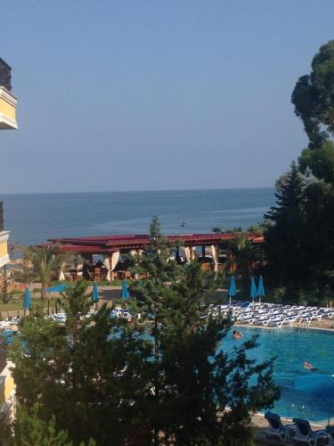 a resort with a swimming pool and the ocean at Dreamland oasis in Chakvi in Chakvi