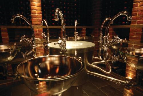 a bathroom with a sink and faucets at Hotel Du Vin Poole in Poole