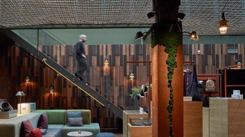 a man walking down a staircase in a building at Downtown Camper by Scandic in Stockholm