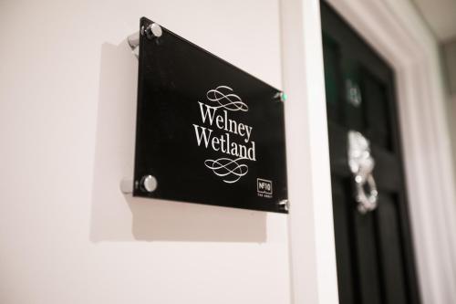 a sign on a door that reads watchwell medieval at Apartments at Number 10 The Abbey in Norwich