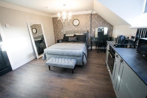 a large bedroom with a bed and a kitchen at Apartments at Number 10 The Abbey in Norwich
