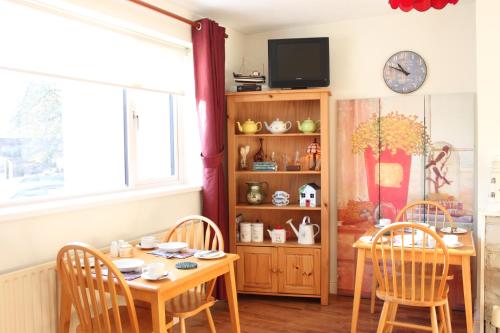 a dining room with a table and chairs and a window at The Bridges Bed and Breakfast in Donegal
