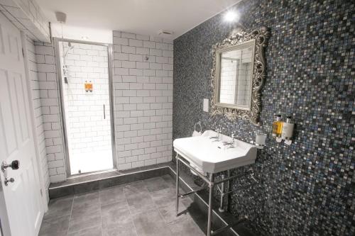 a bathroom with a sink and a mirror on the wall at Apartments at Number 10 The Abbey in Norwich