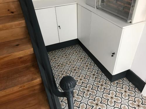a hallway with a carpeted floor and white cabinets at Garcia Place in Lisbon