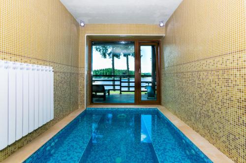 a swimming pool in a house with a view at Romantica Forest Guest House in Dospat
