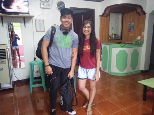 a man and a woman standing in a room at Moalboal Guesthouse in Moalboal