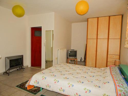 a bedroom with a large bed and a tv at Small studio near the center of Tripoli in Tripolis