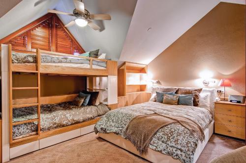 a bedroom with two bunk beds and a ceiling at Village Hall by East West Hospitality in Beaver Creek