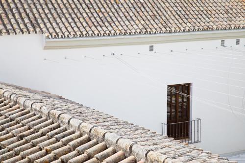 a roof of a white building with a window at One Shot Conde Torrejón in Seville