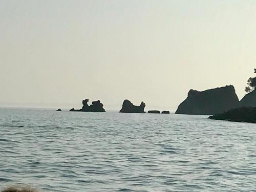 a large body of water with rocks in the background at Chambres du Bout du Monde in Landévennec