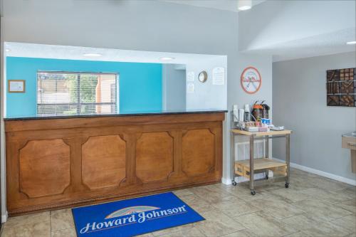 a bar in a room with a blue wall at Howard Johnson by Wyndham Vicksburg in Vicksburg