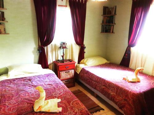 two toy ducks sitting on beds in a bedroom at Cabañas de Campo in Santa María