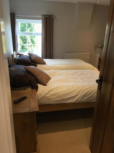a bedroom with a bed and a window at Maypole Farm, Cawood in Selby