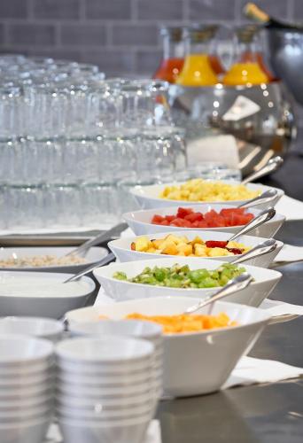 a buffet line of plates and bowls of food at Hotel Elbresidenz an der Therme in Bad Schandau