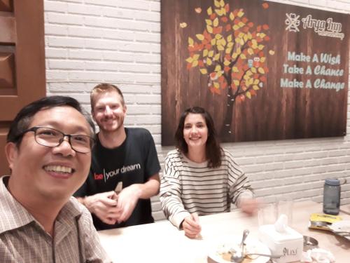 a group of people sitting at a table at Arya Inn in Pematangsiantar