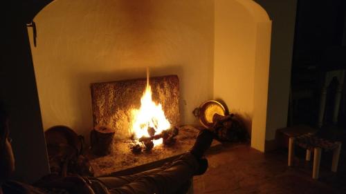 a person is standing in front of a fireplace at Monte da Estrela - Country House & SPA in Moura
