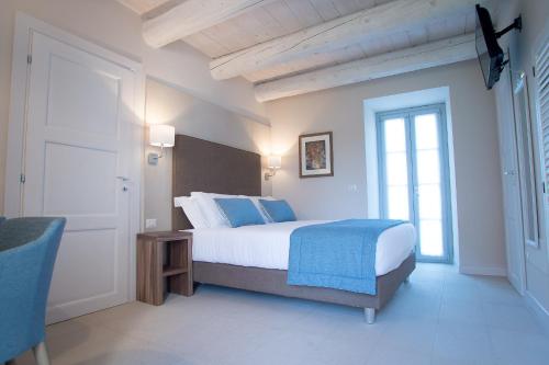 a bedroom with a bed and a window and a door at Agromarino in Sirolo
