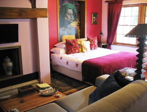 a room with two beds and a couch and a fireplace at Fleur Bleue & The Timber Frame in Heidelberg