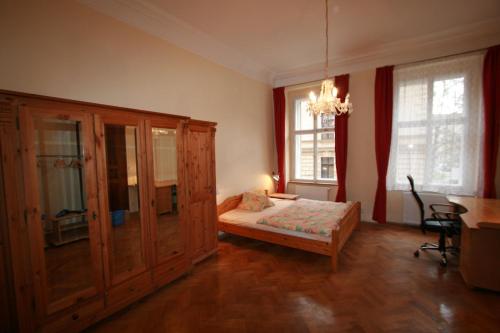 a bedroom with a bed and a large wooden cabinet at Apartment No 0B Petrinska 18 - Mala Strana in Prague