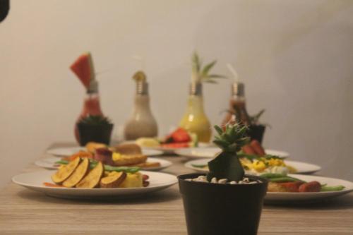 a table with plates of food and bottles of champagne at Casa Blanca Gili Air in Gili Air