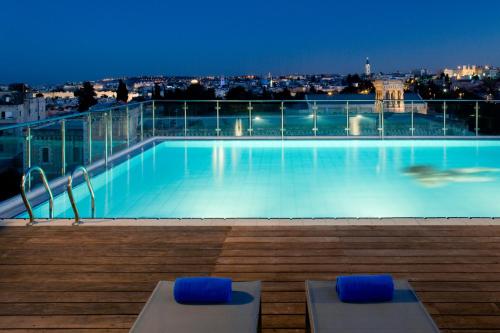 a large swimming pool on top of a building at St. George Hotel in Jerusalem