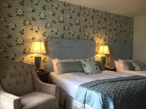 a bedroom with a bed and a chair at The Landmark Hotel in Carrick on Shannon
