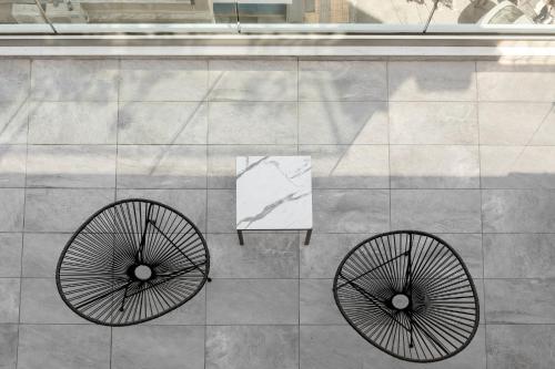 a pair ofokedoked wheels on the side of a building at 360Degrees Pop Art Hotel in Athens