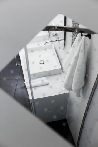 a bathroom with a sink and a mirror at 360Degrees Pop Art Hotel in Athens