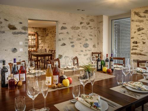 une salle à manger avec une table et des verres à vin dans l'établissement coltiviamo-sogni, à Campascio