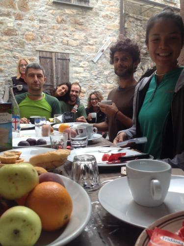 a group of people sitting at a table with food at Medieval Village B&B in Ne
