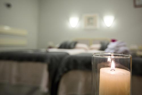 a candle sitting on a table in a living room at Hostal Paris in Valladolid