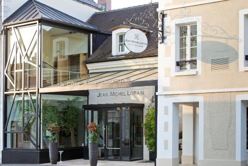 a store front of a building with potted plants at La Côte Saint Jacques in Joigny