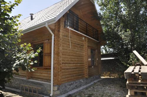 a log cabin with a porch and a roof at Fairy Tale in Gabala
