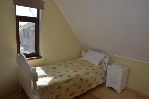 a small bedroom with a bed and a window at Fairy Tale in Gabala