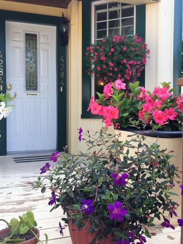a porch with flowers in front of a door at Ellis House Bed & Breakfast in Niagara Falls
