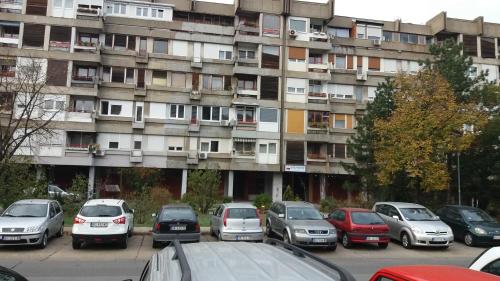 a parking lot with cars parked in front of an apartment building at WHITE CITY 2 in Belgrade