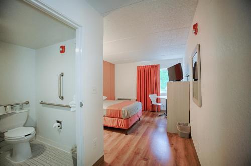 a hotel room with a bed and a bathroom at Motel 6-Albany, NY in Albany